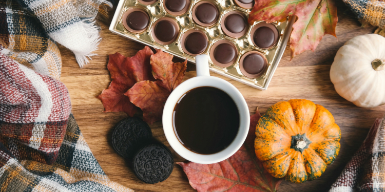 flatlay of fall leaves, cookies and mug of coffee