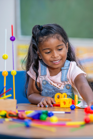 Child playing with blocks and toys