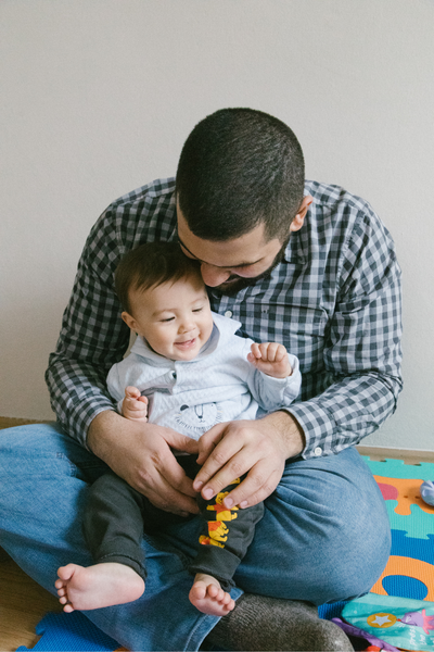 Seated adult holding baby