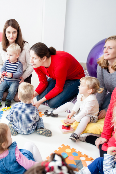 Kids with moms sitting at storytime