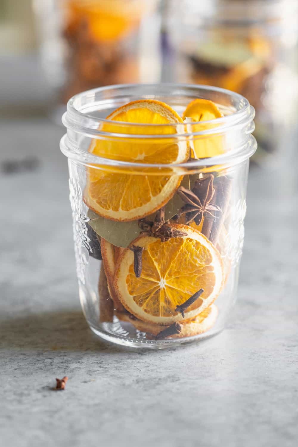 Glass jar filled with oranges and spices